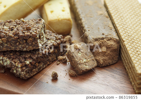 Square columnar solid nutrition-adjusted food on a wooden board Square columnar solid nutrition-adjusted food on a wooden board 86319855