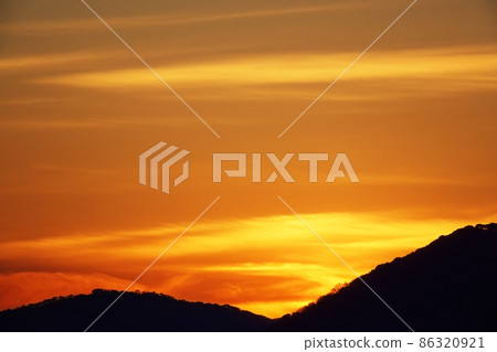 Winter / mountain silhouette and sunrise sky / telephoto 86320921