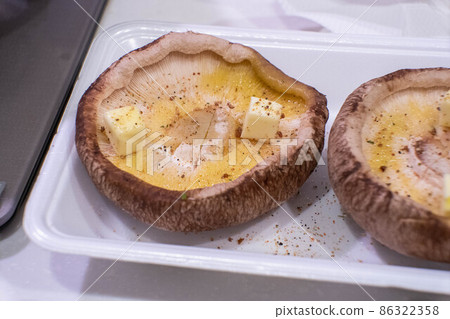 Shiitake mushrooms and butter before baking 86322358