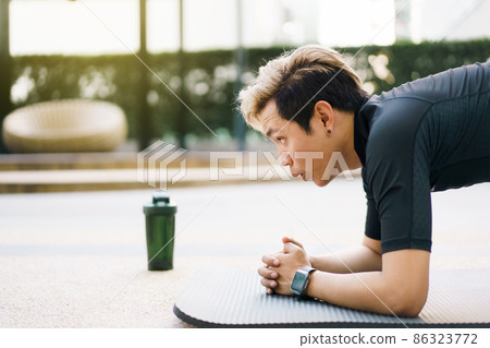 Active Asian young man making an outdoor body weight exercise close up, sportsman doing body weight workout by pushup and plank. Asian sportsman exercising for muscle and body building. Active Asian young man making an outdoor body weight exercise close up, sportsman doing body weight workout by pushup and plank. Asian sportsman exercising for muscle and body building. 86323772