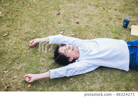 A man lying on the lawn A man lying on the lawn 86324271
