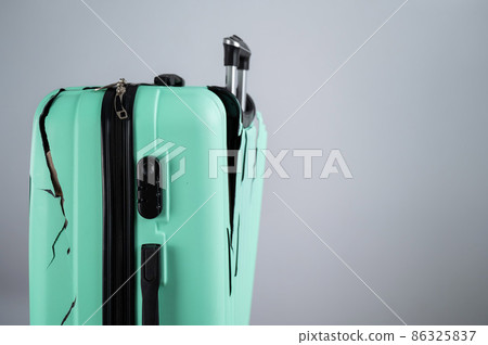Close-up of a broken plastic suitcase on a white background. 86325837