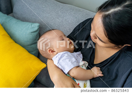 Adorable baby girl sleeping on her mother's hand 86325843