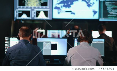 Group of People in Mission Control Center filled with Displays, Celebrating Successful Rocket Launch. 86325893