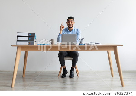 Idea Concept. Excited Man Pointing Finger Up At Workplace Idea Concept. Excited Man Pointing Finger Up At Workplace 86327374