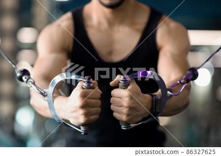 Power And Strength. Muscular Male Athlete Training With Crossover Machine At Gym 86327625