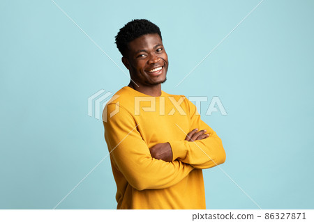 Positive young black man posing on blue 86327871