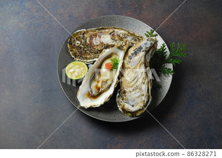 Lots of fresh raw oysters and oyster ponzu Lots of fresh raw oysters and oyster ponzu 86328271