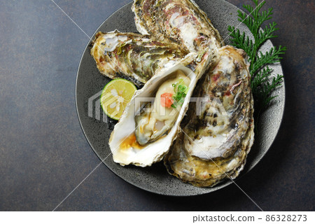 Lots of fresh raw oysters and oyster ponzu Lots of fresh raw oysters and oyster ponzu 86328273