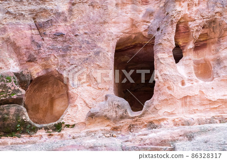 Cave in the rock in the city of Petra, Jordan. Petra is a historical and archaeological city in southern Jordan. 86328317