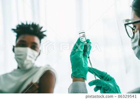 Young man visits skillful doctor at hospital for vaccination 86329541