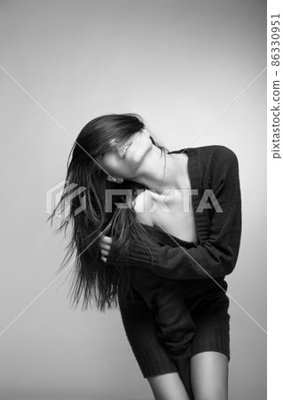 Attractive smiling woman with long hair on grey Attractive smiling woman with long hair on grey 86330951