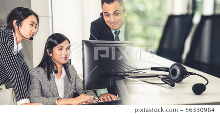 Business people wearing headset working in office broaden view Business people wearing headset working in office broaden view 86330984