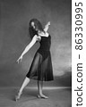 Modern style dancer posing on grey background 86330995