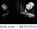 Beautiful young woman near a glass in interior 86331010