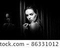 Beautiful young woman near a glass in interior 86331012