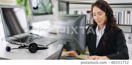 Business people wearing headset working in office broaden view Business people wearing headset working in office broaden view 86331752