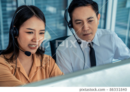 Business people wearing headset working actively in office Business people wearing headset working actively in office 86331840