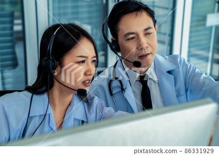 Doctor team wearing headset talking actively on video call in hospital clinic 86331929