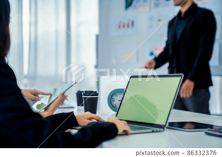 Businesswoman in business meeting using computer proficiently at office room . 86332376