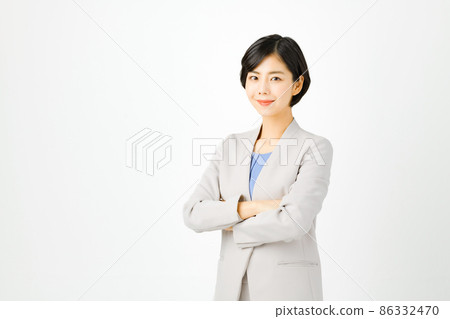 Young business woman in a suit with a smile looking at the camera (white background) Young business woman in a suit with a smile looking at the camera (white background) 86332470