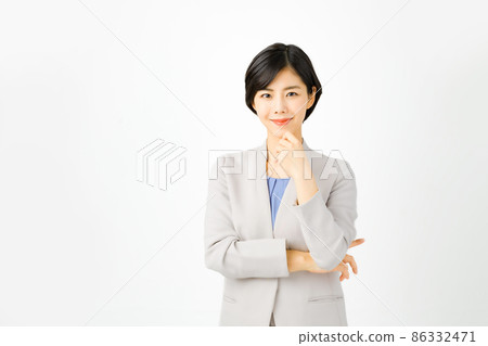 Young business woman in a suit with a smile looking at the camera (white background) Young business woman in a suit with a smile looking at the camera (white background) 86332471