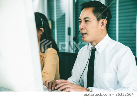 Business people wearing headset working actively in office Business people wearing headset working actively in office 86332564