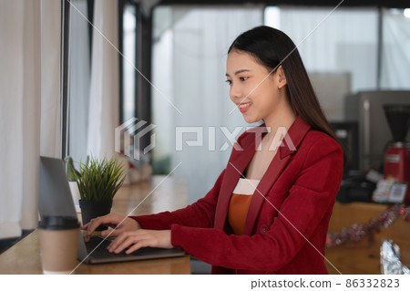 A business woman using laptop computer to cyber security for her saving account, business, technology, future, digital asset Concept. A business woman using laptop computer to cyber security for her saving account, business, technology, future, digital asset Concept. 86332823