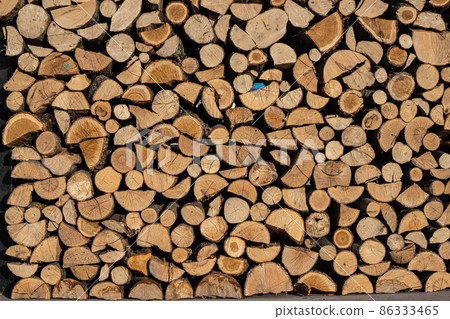 Pile of stacked triangle firewood prepared for fireplace and boiler 86333465