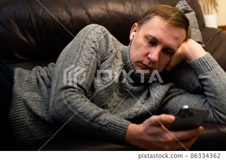 man using a smartphone man using a smartphone 86334362