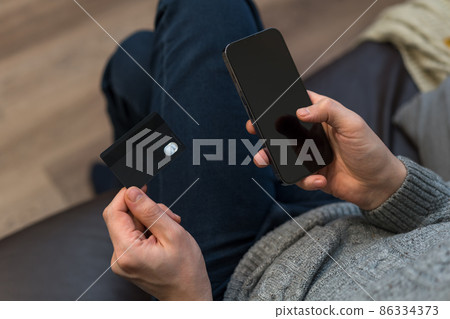 man use smartphone and credit card 86334373