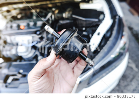 Old gear oil filter of the car transmission system on the mechanic hand 86335175