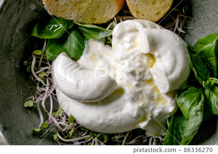 Traditional italian burrata knotted cheese in bowl 86336270