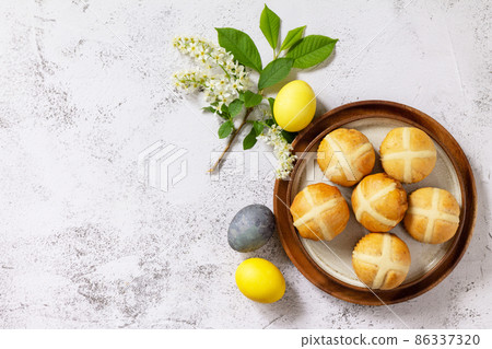 Easter baking. Homemade Easter traditional hot cross buns on a gray stone tabletop. Top view flat lay background. Copy space. 86337320