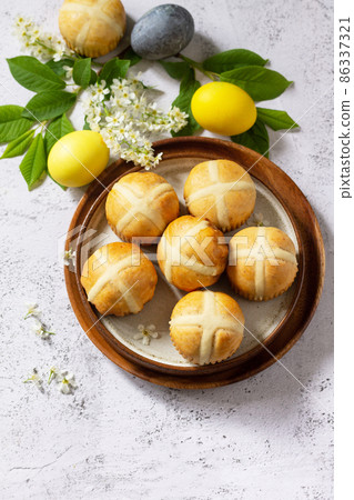 Easter baking. Homemade Easter traditional hot cross buns on a gray stone tabletop. Copy space. 86337321
