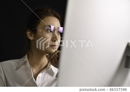 Asian woman sitting looking deep in thought exhausted and tired during working and using computer Asian woman sitting looking deep in thought exhausted and tired during working and using computer 86337396