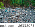 Trash around the Ko Hin Ngam rocky island 86338073