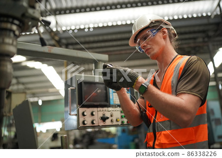 Industry engineer worker operate control heavy machine in factory. 86338226