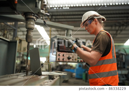 Industry engineer worker operate control heavy machine in factory. 86338229