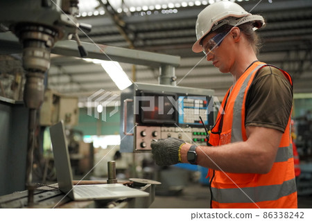 Industry engineer worker operate control heavy machine in factory. Industry engineer worker operate control heavy machine in factory. 86338242
