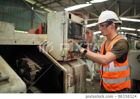 Industry engineer worker operate control heavy machine in factory. Industry engineer worker operate control heavy machine in factory. 86338324