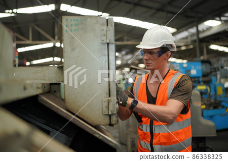 Industry engineer worker operate control heavy machine in factory. Industry engineer worker operate control heavy machine in factory. 86338325