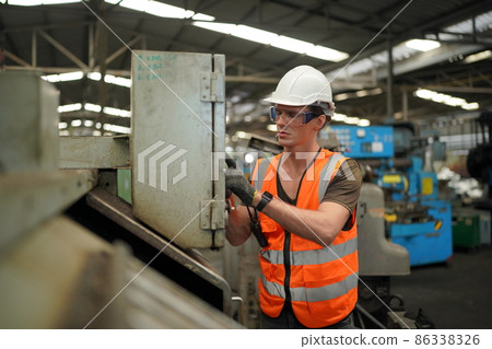 Industry engineer worker operate control heavy machine in factory. 86338326