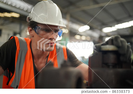 Industry engineer worker operate control heavy machine in factory. Industry engineer worker operate control heavy machine in factory. 86338373