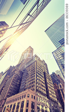 Manhattan old and modern buildings against the sun, color toning applied, New York City, USA. Manhattan old and modern buildings against the sun, color toning applied, New York City, USA. 86339369