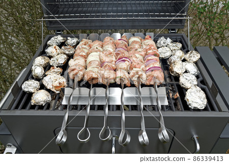 Shashlik while preparing on black barbecue grill Shashlik while preparing on black barbecue grill 86339413