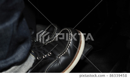 Accelerate and Brake. Foot pressing foot pedal of a car to drive ahead. Accelerator and brake pedal in a car. Driver driving the car by pushing accelerator pedals of the car. inside vehicle automobile 86339458