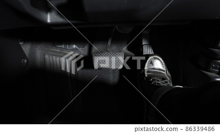 Accelerate and Brake. Foot pressing foot pedal of a car to drive ahead. Accelerator and brake pedal in a car. Driver driving the car by pushing accelerator pedals of the car. inside vehicle automobile Accelerate and Brake. Foot pressing foot pedal of a car to drive ahead. Accelerator and brake pedal in a car. Driver driving the car by pushing accelerator pedals of the car. inside vehicle automobile 86339486
