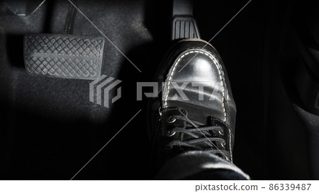 Accelerate and Brake. Foot pressing foot pedal of a car to drive ahead. Accelerator and brake pedal in a car. Driver driving the car by pushing accelerator pedals of the car. inside vehicle automobile Accelerate and Brake. Foot pressing foot pedal of a car to drive ahead. Accelerator and brake pedal in a car. Driver driving the car by pushing accelerator pedals of the car. inside vehicle automobile 86339487