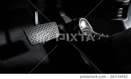 Accelerate and Brake. Foot pressing foot pedal of a car to drive ahead. Accelerator and brake pedal in a car. Driver driving the car by pushing accelerator pedals of the car. inside vehicle automobile Accelerate and Brake. Foot pressing foot pedal of a car to drive ahead. Accelerator and brake pedal in a car. Driver driving the car by pushing accelerator pedals of the car. inside vehicle automobile 86339492